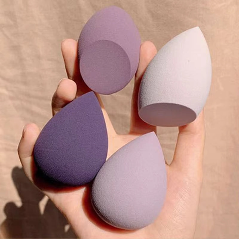Mystore makeup sponge set featuring four teardrop-shaped sponges in various shades of purple