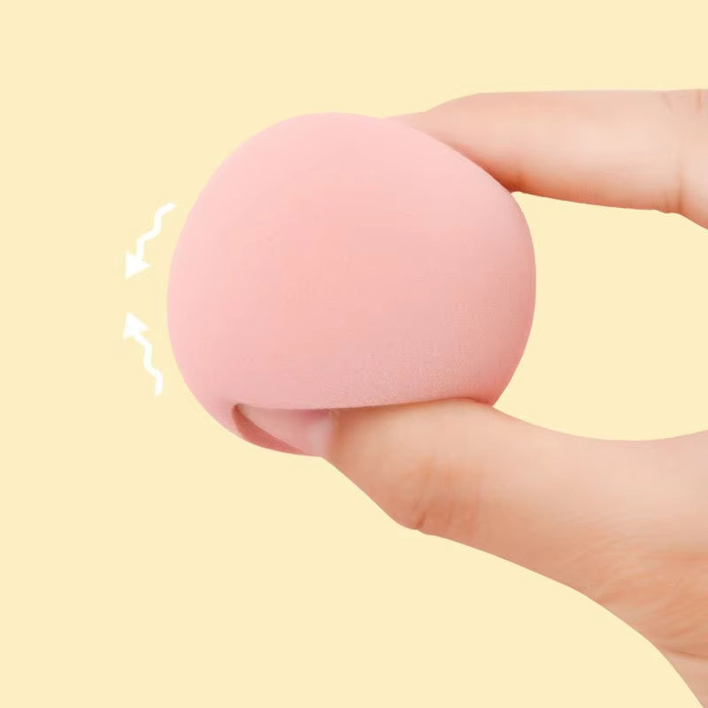 Mystore makeup sponge set held in a hand, featuring a soft pink design for flawless makeup application