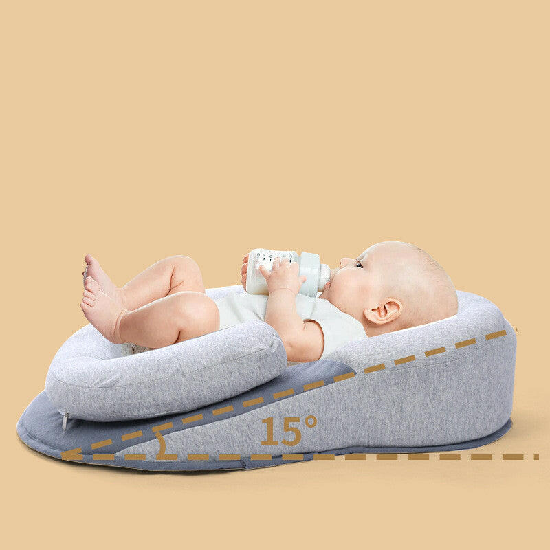 Safe baby pillow for newborns with 15-degree incline, providing comfort and support for infants during feeding