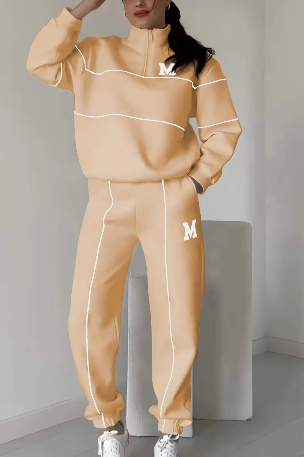 Beige women's lounge sweatsuit set with white piping and M logo, hoodless two-piece outfit