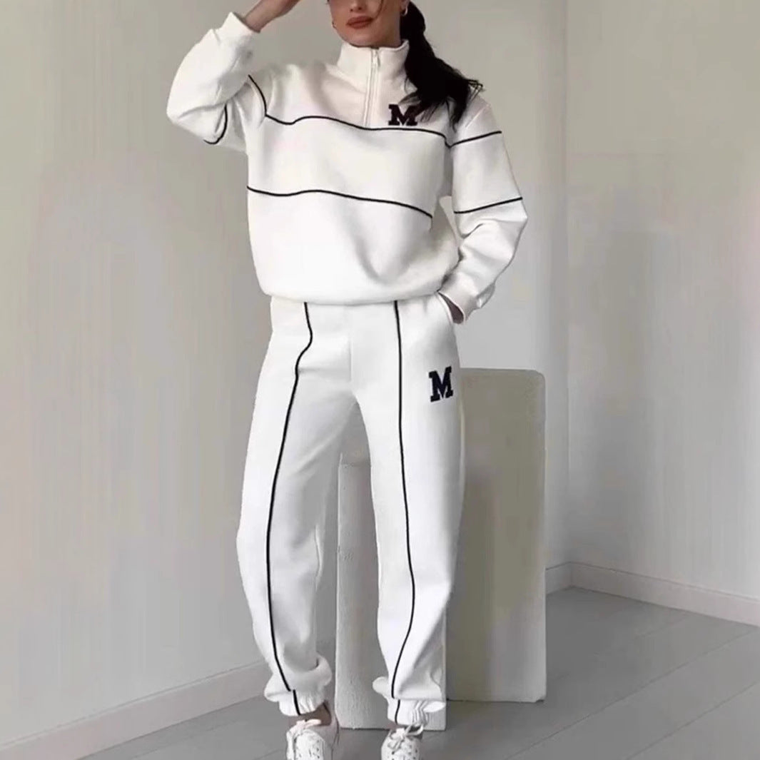 White women's lounge sweatsuit set with black piping and letter M detailing two piece outfit