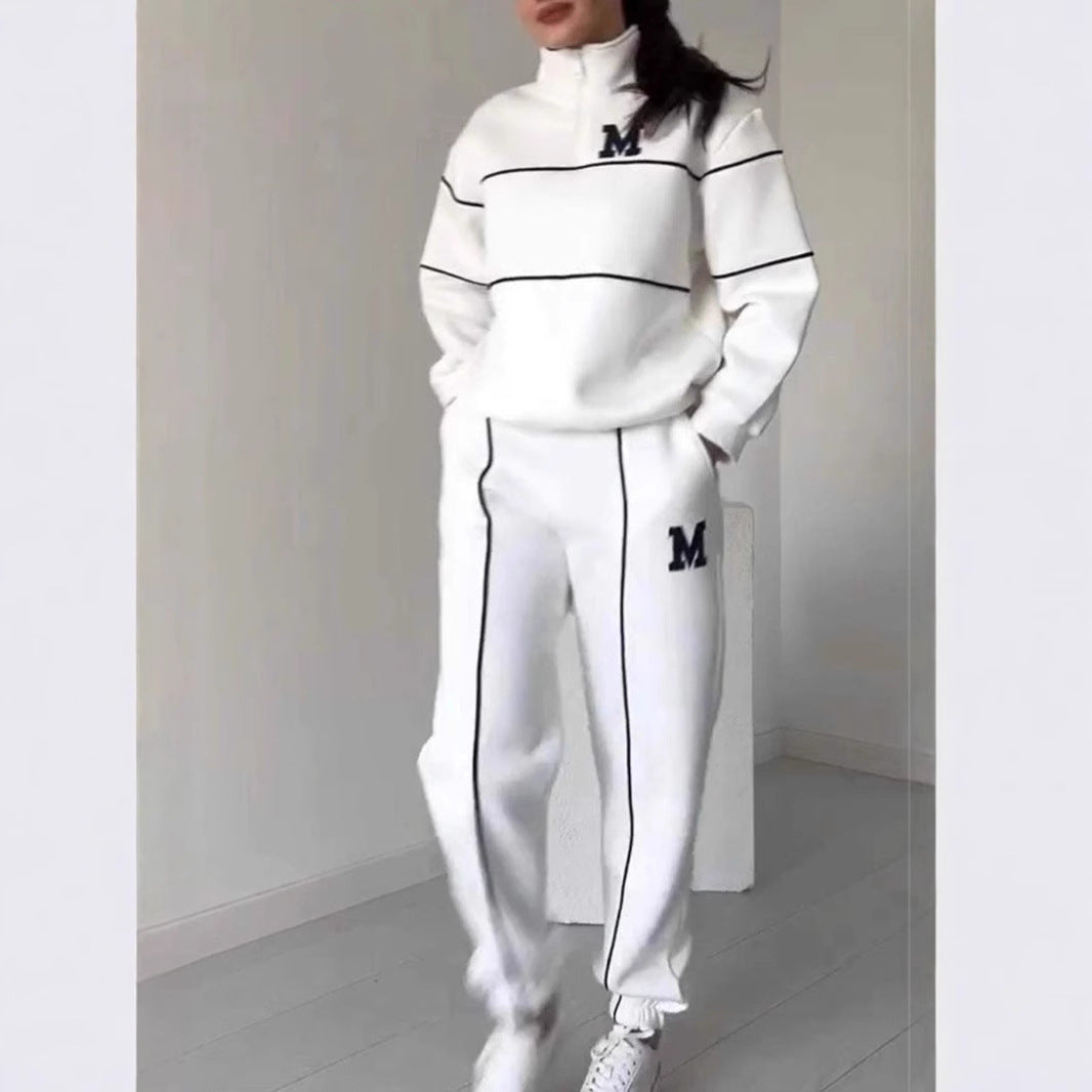 White women's lounge sweatsuit set from Mystore with black piping and M logo on top and pants