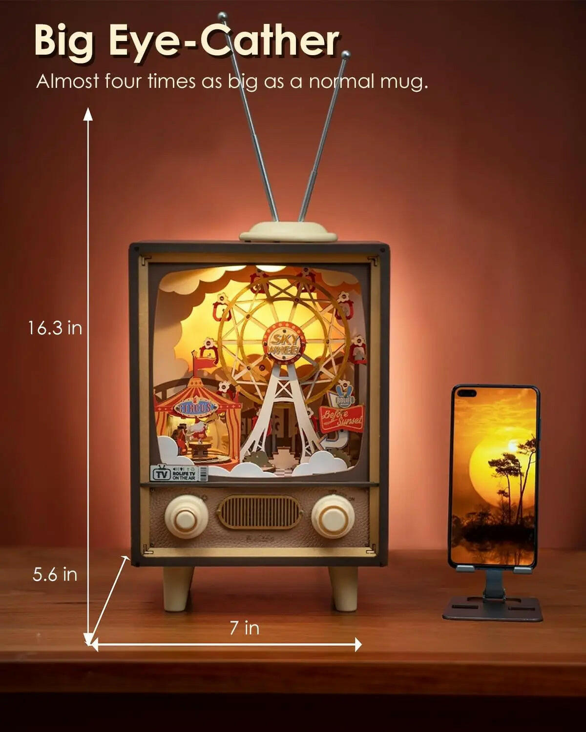 Big Eye-Catcher 3D wooden puzzle music box displayed alongside a smartphone for size comparison
