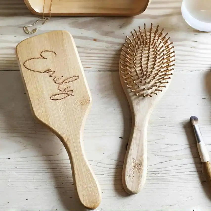 Custom engraved wooden hair brush with personalized name design on natural wood finish