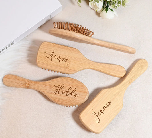 Custom engraved wooden hair brush set featuring personalized names on elegant bamboo styles