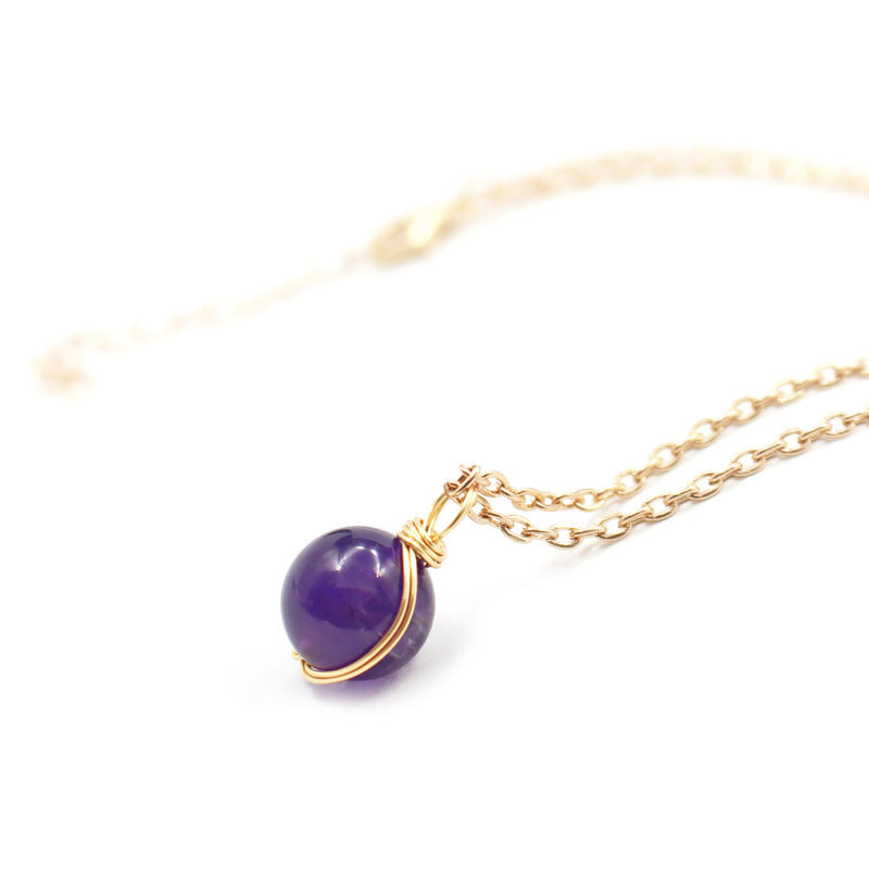 Elegant natural crystal pendant women on a gold chain, featuring a beautiful purple crystal